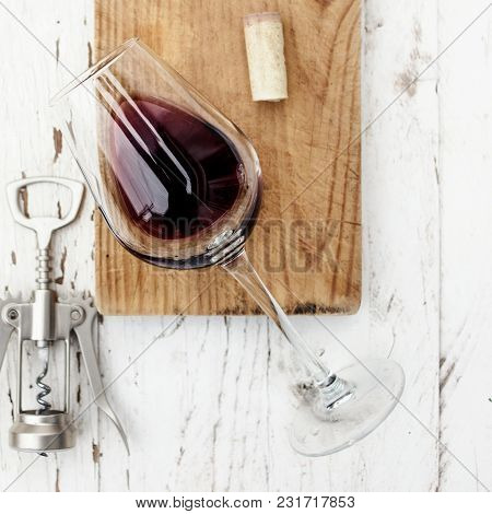 Wine Tasting Concept - Red  Wine Glass And Corkscrew On White Wooden Table With Copespace