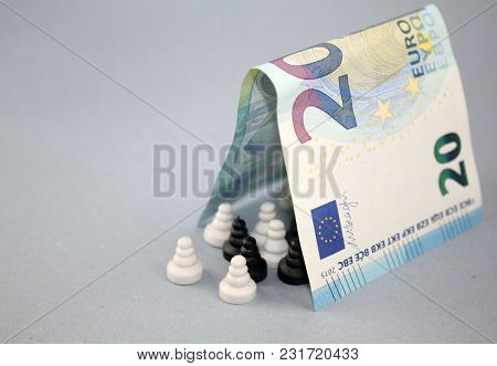 20 Euro Banknote As A Roof Over Black And White Chess Pawns, Concept Of Multicultural Europe, Tolera