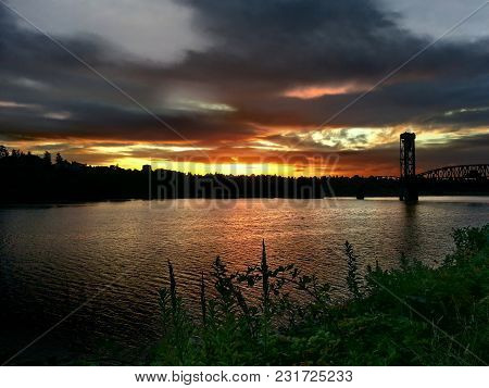 Looking Over The Willamette River And A Railroad Bridge At A Sunrise Above St Johns, Portland Oregon