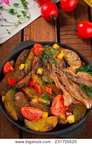 Fried Potatoes With Bacon And Fresh Tomatoes In The Frying Pan. Wooden Rustic Background. Top View.