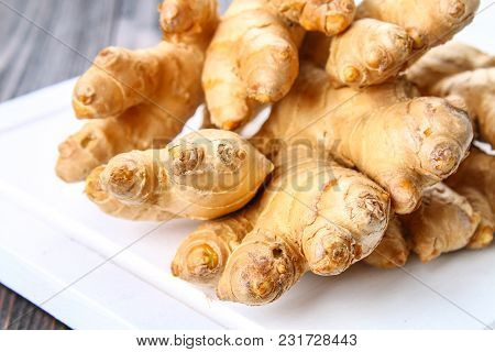Spicy Root Of Ginger On A Wooden Table