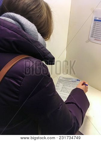 Moscow, Russia - March 18, 2018: The Voter Votes In The Booth For Voting At Elections Of President.