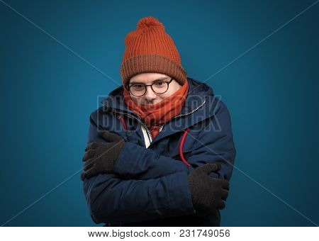 Handsome young boy freezing in warm clothing with copy space