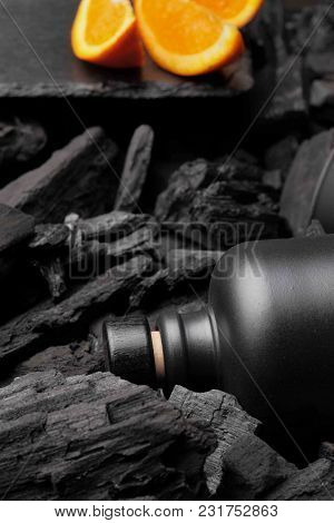 Black Matte Bottle Of Vodka Or Tequila.slices Of Oranges. Defocused On Charcoal Background. Black Ed
