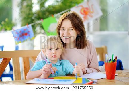 Cute Little Boy Drawing And Painting With Colorful Markers Pens At Kindergarten. Creative Kid Painti