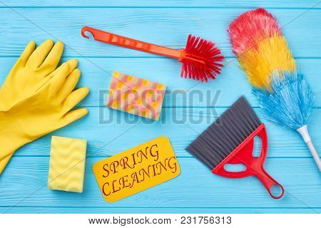 House Cleaning Products On Wood Background. Collection Of Collorful Tools For Cleaning On Blue Woode