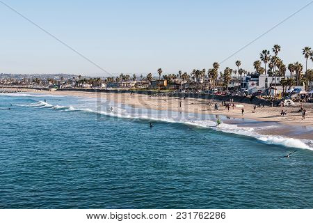 San Diego, California/usa - February 3, 2018:  People Enjoy A Morning On The Beach, While Surfers Ch