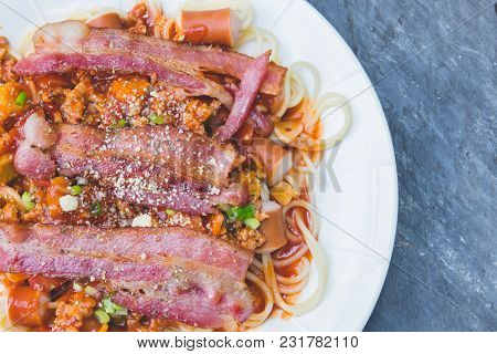 Spaghetti With Tomato Sauce And Suasage With Bacon In White Dish