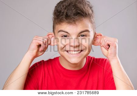 Silly Boy Making Grimace - Funny Monkey Face. Child With Big Ears, Isolated On White Background. Emo