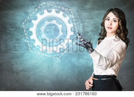 Young Business Woman With Robot Hand Point On Digital Cogwheels. Hand Prosthesis Concept.
