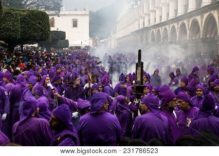 Antigua, Guatemala: March 18 2018: Hunderds Of Purple Robed Men And Incense Smoke At The Procession 