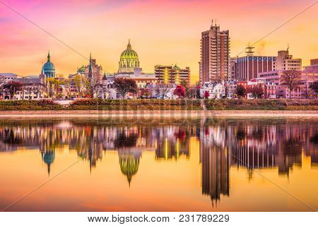 Harrisburg, Pennsylvania, USA downtown skyline on the Susquehanna River at dusk.