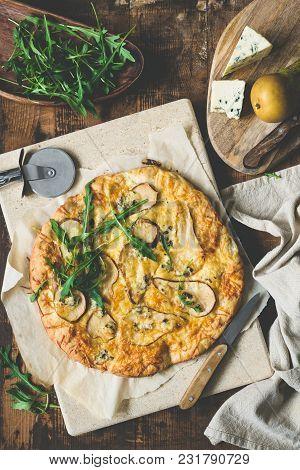 Pear Blue Cheese Quatro Formaggi Pizza Garnished With Arugula On Rustic Wood, Table Top View, Toned 