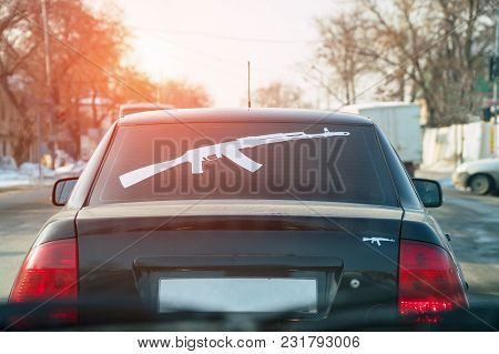 Figure Kalashnikov Rifle On The Rear Window Of The Car