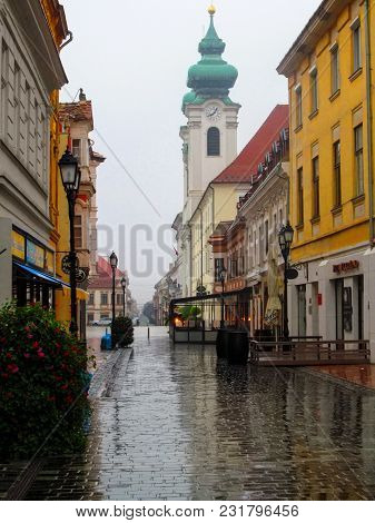 Hungary, Gyor - August 31, 2014: Kazinczy Utca (street) And Benedictine Church On Széchenyi Square O