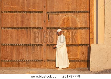 Al Ain, Uae - November 18, 2005: An Unidentified Caretaker At The Entrance To The Iconic Al Jahli Fo