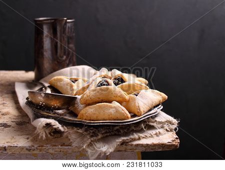 Hamantaschen Cookies With Poppy Seed And Risins And Icing Sugar On A Plate, Cooked For Jewish Festiv
