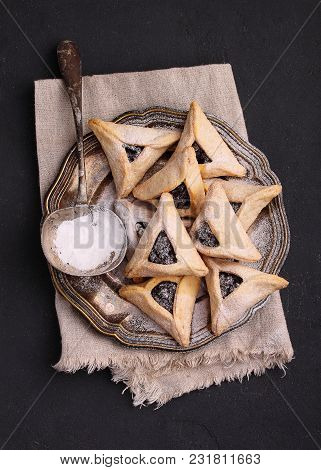 Hamantaschen Cookies With Poppy Seed And Risins And Icing Sugar On A Plate, Cooked For Jewish Festiv