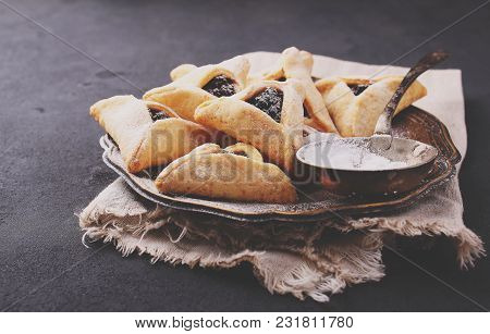 Hamantaschen Cookies With Poppy Seed And Risins And Icing Sugar On A Plate, Cooked For Jewish Festiv