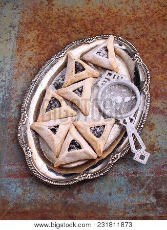 Hamantaschen Cookies With Poppy Seed And Risins And Icing Sugar On A Plate, Cooked For Jewish Festiv
