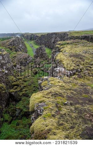 Thingvellir, Iceland - July 19, 2017: Tourists Walk Through The Almannagja Fault Line In The Mid-atl