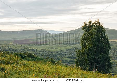 Summer Landscape In Mountains And The Dark Drey Sky With Clouds