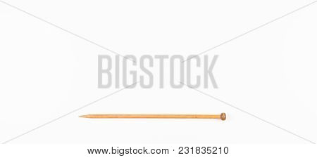 Wooden Knitting Needle On White Background. Top View