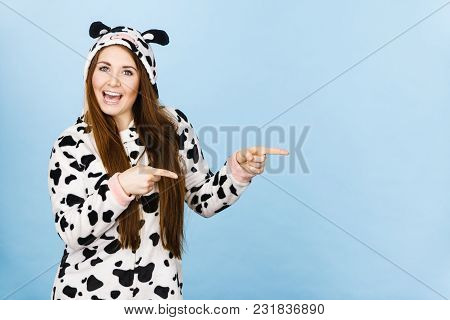 Happy Teenage Girl In Funny Nightclothes, Pajamas Cartoon Style Pointing At Copy Space With Positive