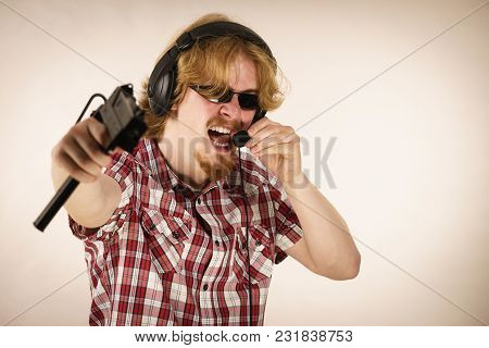 Nerd Geek Young Adult Man Playing On The Video Console Holding Gun Wearing Headphones With Microphon