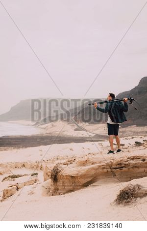 Photographer With Camera Looking For Motive Of Unique Landscape. Sand Dunes And Volcanic Cliffs On T