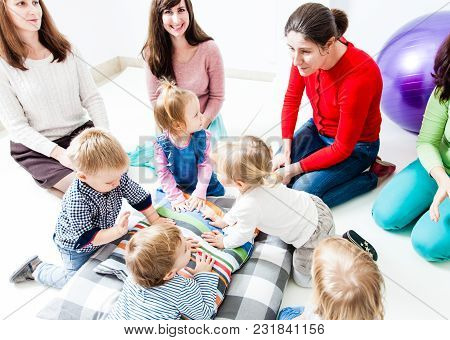 The First Acquaintance Of Children In The Kindergarten. Moms Acquaint Children To Each Other. Moms P