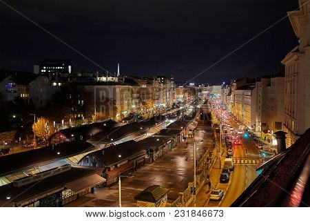 Urban street at night with traffic. Vienna Naschmarkt