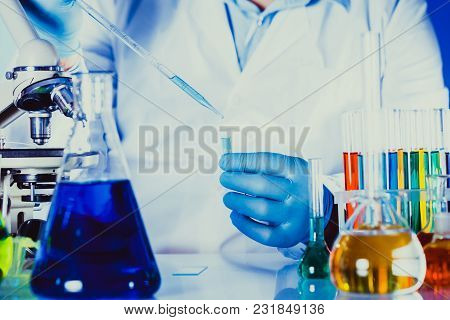 Scientist Holds Eppendorf Tube And Pipette. Focus On Test Tube