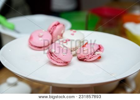 Close Up Bright Pink And White French Cookies Macarons On White Stand