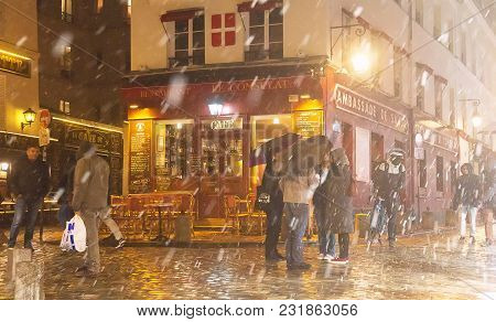 Paris , France- March 17, 2018: View Of Typical Parisian Cafe Le Consulat During Snowfall . It Is Lo