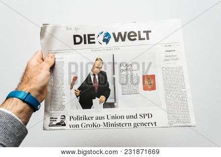 Paris, France - Mar 19, 2017: Man Reading German Die Welt Newspaper At Press Kiosk Featuring Russian