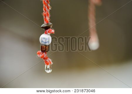 Martenitsa With Smile And Water Drop Under The Rain .