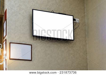 Televisor On A Wall With A Blank Frame For Your Advertising