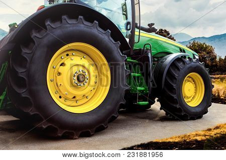 15 March 2018 Green Tractor Fendt With Yellow Wheels, Against The Background Of The Field, Side View