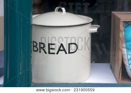 An Old Saucepan With The Inscription Bread In The Window Of An Antique Store.