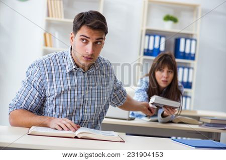 Students sitting and studying in classroom college
