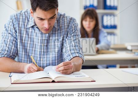 Students sitting and studying in classroom college