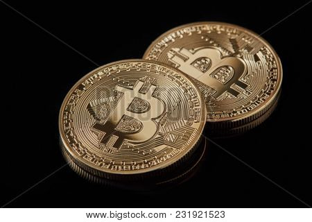 Digital currency physical golden bitcoin coins on black background
