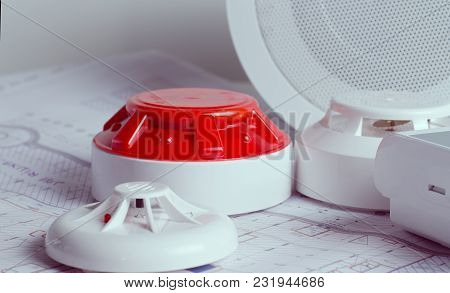 Fire Security Equipment And Blueprint On A Table. Good For Security Servise Engeniering Company Site