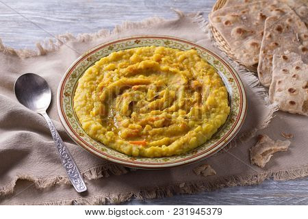 Stewed Yellow Peas With Carrots, Onions And Spices On A Wooden Table With Chapatti, Selective Focus