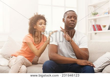 Young African-american Couple Making Peace After Quarreling At Home, Man Still Feeling Offended. Fam