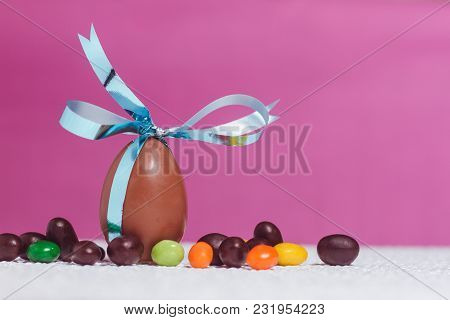 Easter Chocolate Egg With Lots Of Chocolate Candies In Decoration
