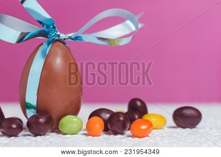 Easter Chocolate Egg With Lots Of Chocolate Candies In Decoration