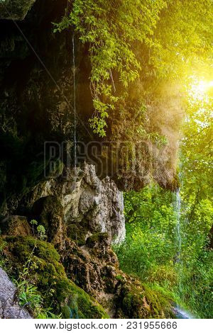 Photo Of Little Beautiful Waterfall Flowing In Cave