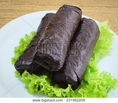 Japanese Cuisine, Traditional Unsliced Japanese Rice Maki Sushi Roll With Nori Seaweed Served On Gre